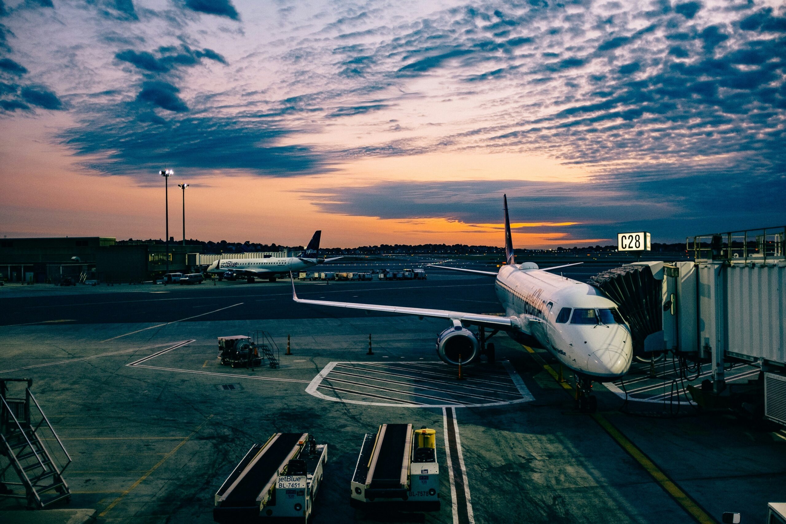 Photo of an airplane at the airport gate at sunrise.