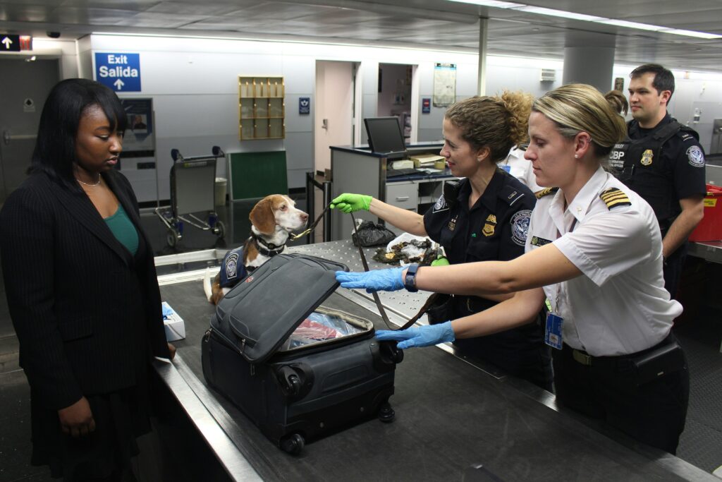 Photo of woman going through airport security checkpoint.